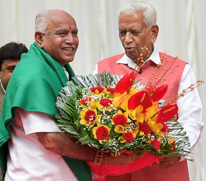 B S Yeddyurappa after being sworn in as Karnataka chief minister, May 17, 2018, with Governor Vajubhai Vala, right. Photograph: Shailendra Bhojak/PTI Photo