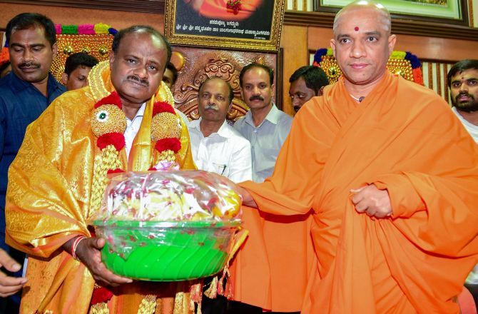 H D Kumaraswamy with Srisri Nirmalanandanatha Swamiji of the Adichunchungiri Mutt in Bengaluru. Photograph: PTI Photo