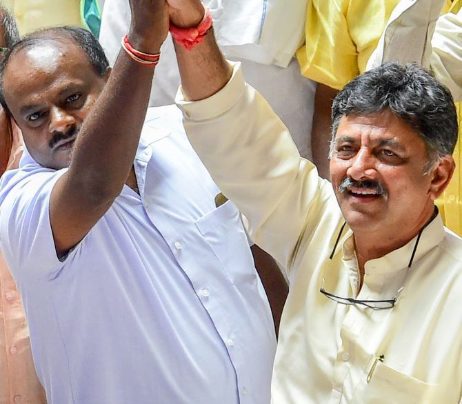 Janata Dal-Secular leader H D Kumaraswamy, left, and Congress leader D K Shivakumar celebrate after B S Yeddyurappa announced his resignation before the floor test, at the Vidhana Soudha, Bengaluru, May 19, 2018. Photograph: Shailendra Bhojak/PTI Photo