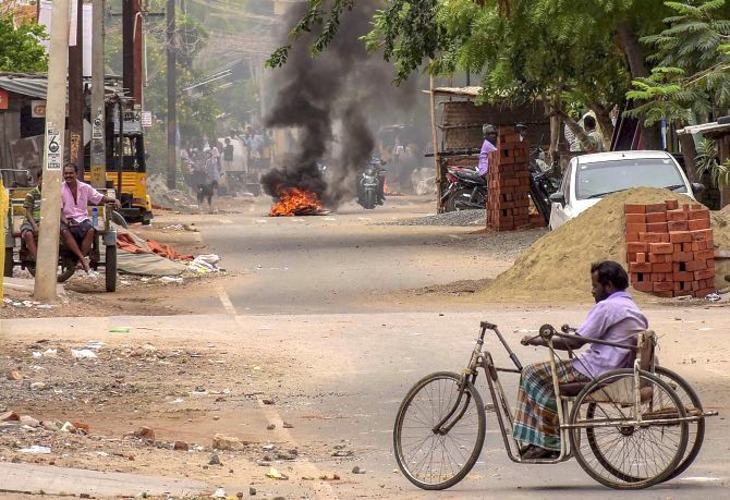 Protesters burn tyres to block a road during the protest demanding the closure of the Sterlite factory in Tuticorin, May 22, 2018.