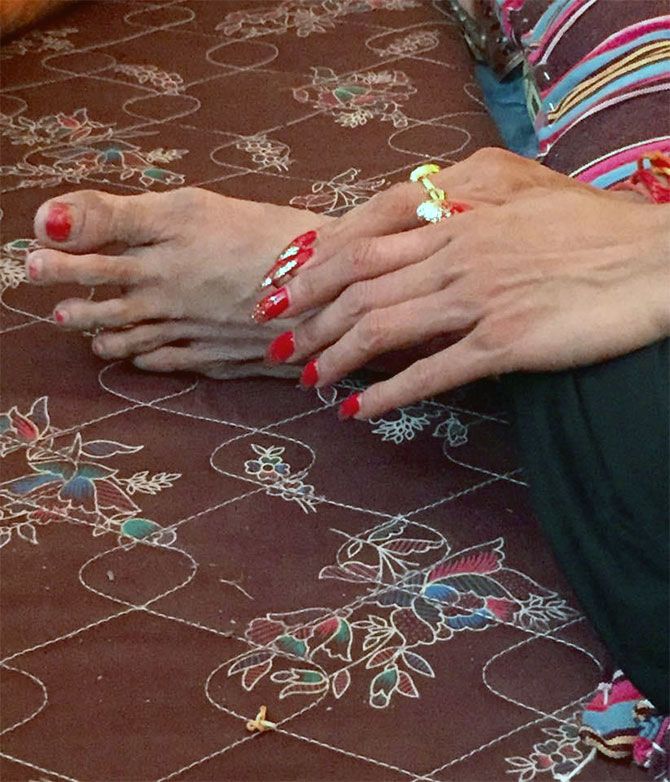 The manicured hands of the head of the Kinnar akhada