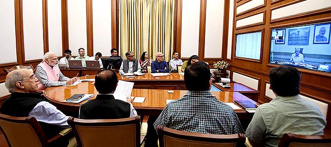 Prime Minister Narendra Damodardas Modi confers with senior bureaucrats via video conferencing