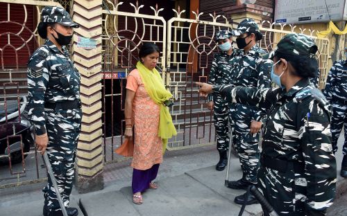 Security personnel question a woman in Assam