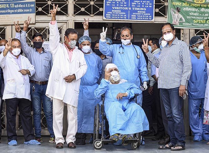 An 82-year old patient, in wheelchair, being discharged from the Loknayak Jayaprakash Narayan Hospital in New Delhi after he fully recovered from coronoavirus despite being in the most vulnerable age category. Photograph: PTI Photo