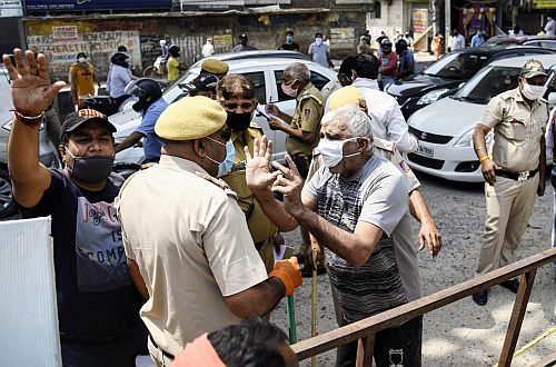 Residents argue with a cop in Delhi