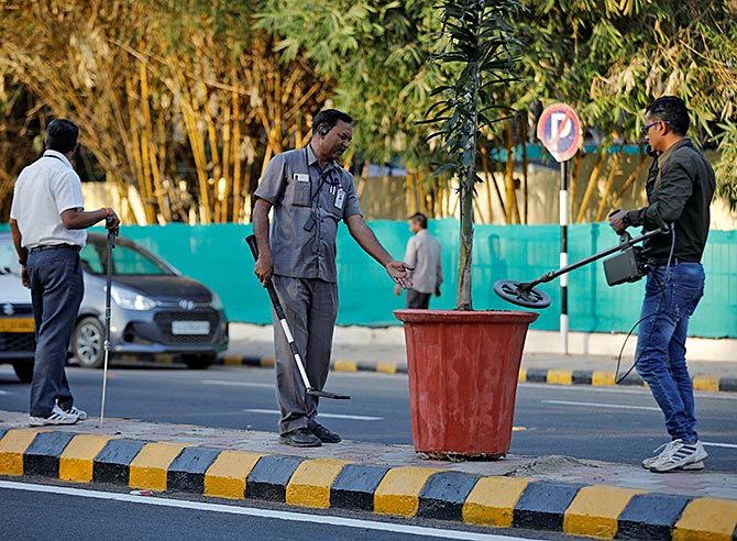 Members of the Gujarat police's bomb disposal squad scan a plant, February 18, 2020, along the route that US President Donald J Trump and Prime Minister Narendra Damodardas Modi will take during Trump's visit to Ahmedabad. Photograph: Amit Dave/Reuters