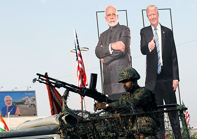 An Indian Army soldier sits atop an armoured vehicle next to cutouts of India's Prime Minister Narendra Damodardas Modi and US President Donald J Trump in Ahmedabad, February 23, 2020. Photograph: Adnan Abidi/Reuters