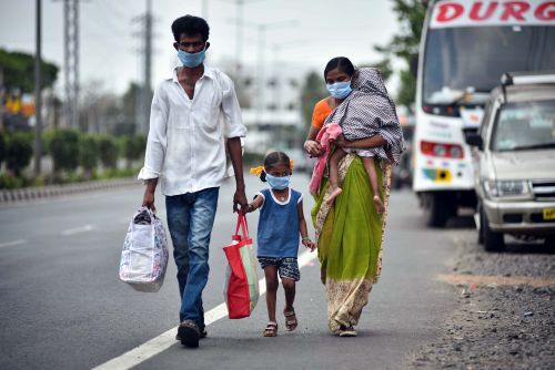 A family in Vijaywada, AP, walks home