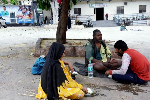 A family eats at a night shelter for homeless in New Delhi