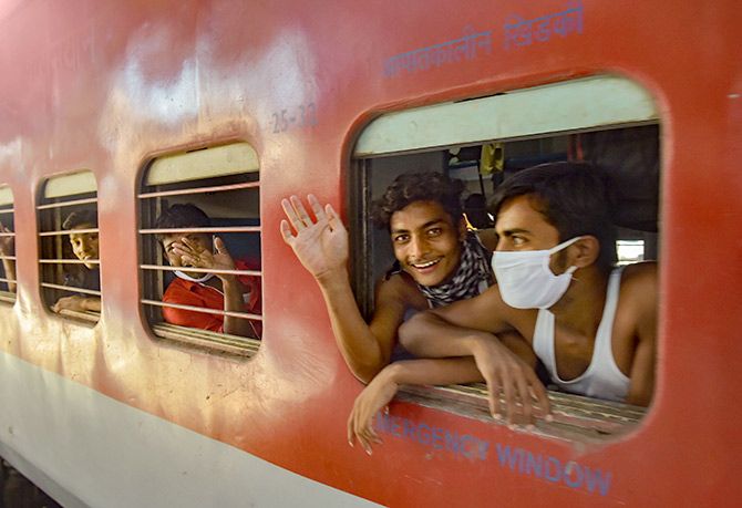 Migrants from Bihar wave as they board a special train to Patna