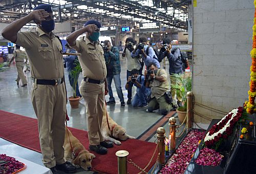 Police personnel and police dogs pay tribute at the 26/11 memorial at CST