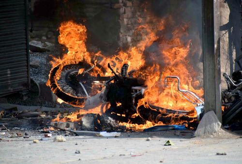A vehicle set ablaze by protestors in Prayagraj