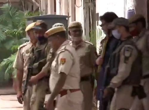 A screen grab of Yasin Malik being taken to court. He is in blue