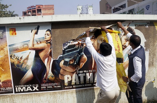 Kalinga Sena supporters tear a poster of the film 'Pathaan' in Bhubaneswar/ANI