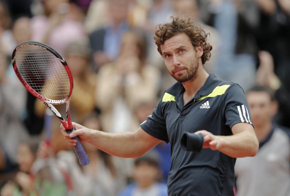 Ernests Gulbis of Latvia reacts after winning his men's singles match against Roger Federer