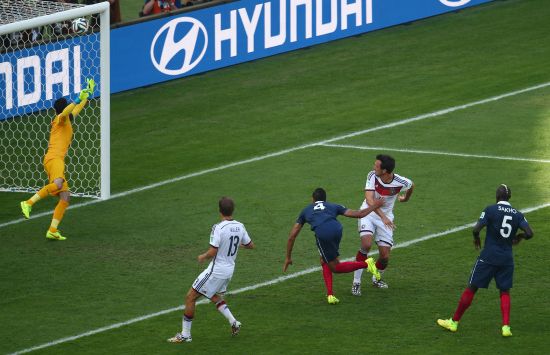 Mats Hummels of Germany scores his team's first goal on a header against Raphael Varane of France 