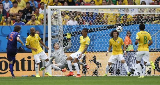 Daley Blind of the Netherlands (L) shoots to score against Brazil 