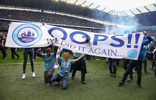 Manchester City fans celebrate at the end of the Barclays Premier League match