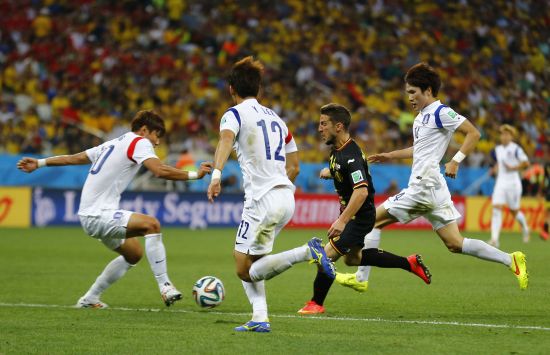 Belgium's Kevin Mirallas fights for the ball with South Korea's Hong Jeong-ho (left), Lee Yong and Han Kook-young (right) 