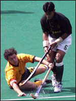 Brent Livermore of Australia is fouled by Sohail Abbas of Pakistan 