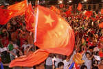 Chinese people celebrate after Beijing was awarded the 2008 Olympics