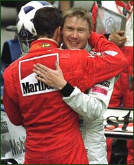 Mika Hakkinen is consoled by Schumacher after the race