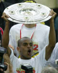 Borussia Dortmund's winning goal scorer Hernrique Ewerthon lifts the German first soccer league trophy 