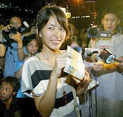A soccer fan in Hong Kong shows her tickets