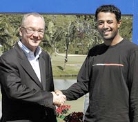 Mel Pyatt (L) president and CEO of Volvo Event Management congratulates Arjun Atwal of India for securing his US PGA tour card 