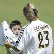 Beckham presents a jersey to a young fan