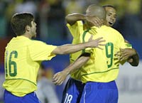 Brazil's Ronaldo (9) celebrates with teammates Juninho Pernambucano (L) and Luis Fabiano after scoring the squad's third goal