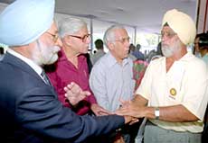 Former Test captain Bishen Singh Bedi chats with some of the Olympians