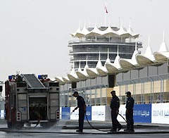 Circuit workers rinse off the new Sakhir circuit in Bahrain