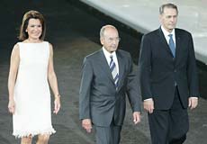 President of Greece Costis Stephanopoulos (C) walks with the President of the Athens 2004 Organising Committee Gianna Angelopoulos-Daskalaki (L) and IOC President Jacques Rogge of Belgium during the opening ceremony of the Athens 2004