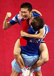 South Korea's Ryu Seung Min celebrates with his coach Kim Taek Soo