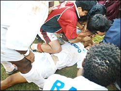 Teammates and bystanders attempt to revive Cristiano de Lima Junior (centre)