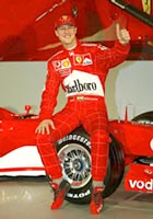 A February 7, 2003 file photo shows Formula One World Champion racing driver Michael Schumacher of Germany posing with the Ferrari F2003GA at the Fiorano race track in Maranello
