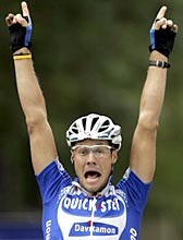 Tom Boonen of Belgium raises his arms as he crosses the finish line