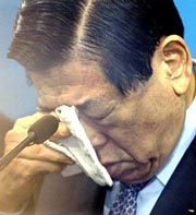 Kim weeps during a news conference at the National Assembly in Seoul on January 9, 2004.