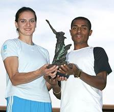 Yelena Isinbayeva of Russia and Kenenisa Bekele of Ethiopia hold the athletes of the year trophy at the IAAF World Athletics Final