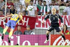 Henrik Larsson scores Sweden's second goal past Bulgaria's goalkeeper Zdravko Zdravkov (R) during their Group C Euro 2004 soccer match at the Jose Alvalade stadium in Lisbon, June 14, 2004.