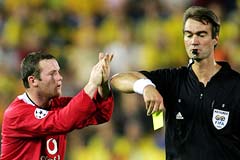 Wayne Rooney applauds the decision by referee Kim Milton Nielsen to book him for a foul