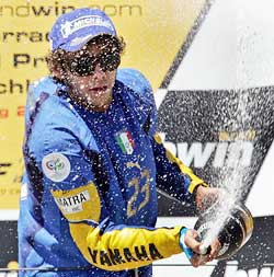 Valentino Rossi celebrates on the podium