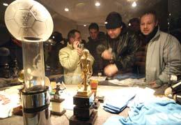 Visitors look at the Maradona display in football museum