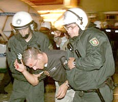 Police detain a German soccer fan after the World Cup 2006 soccer match between Poland and Germany in Dortmund.