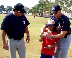 David Palese (left) and Jeff Brueggemann help a kid during the two-day baseball clinic in Mumbai