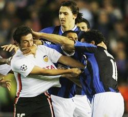 Tempers flare between Valencia's Viana Hugo (left) and Nicolas Burdisso of Inter Milan after the final whistle