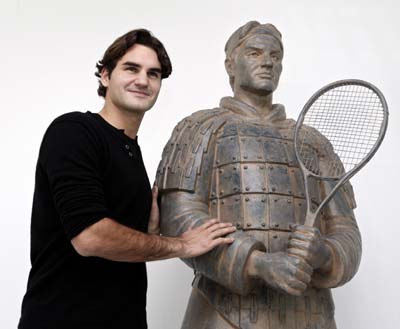 Roger Federer with his statue