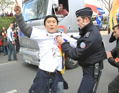 A protestor disrupts the torch relay in Paris