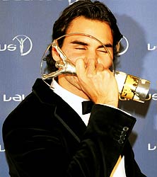 Roger Federer celebrates winning the Laureus Sportsman of the Year award